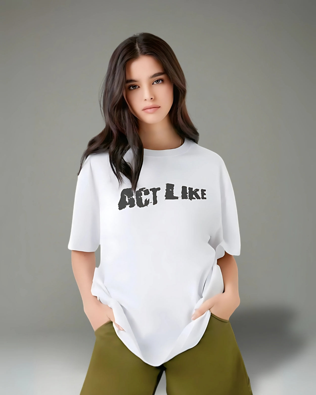 Woman wearing a white t-shirt with 'ACT LIKE' text on a gray background