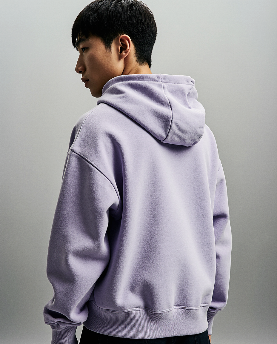 Person wearing a light purple hoodie against a plain background